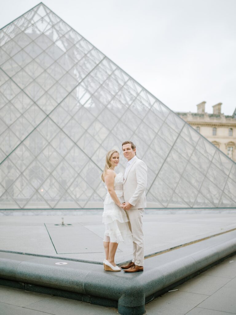 Elegant couple photos in front of Louvre Paris France wedding photographer