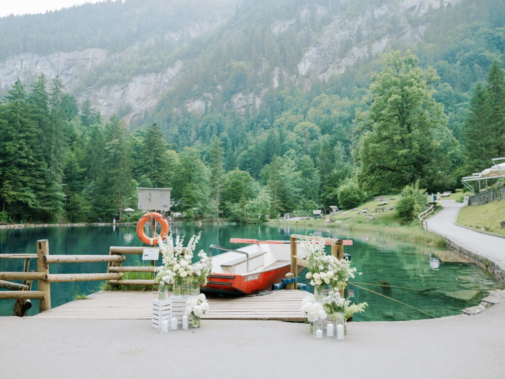 Intimate lakeside elopement ceremony setup with mountains in the background