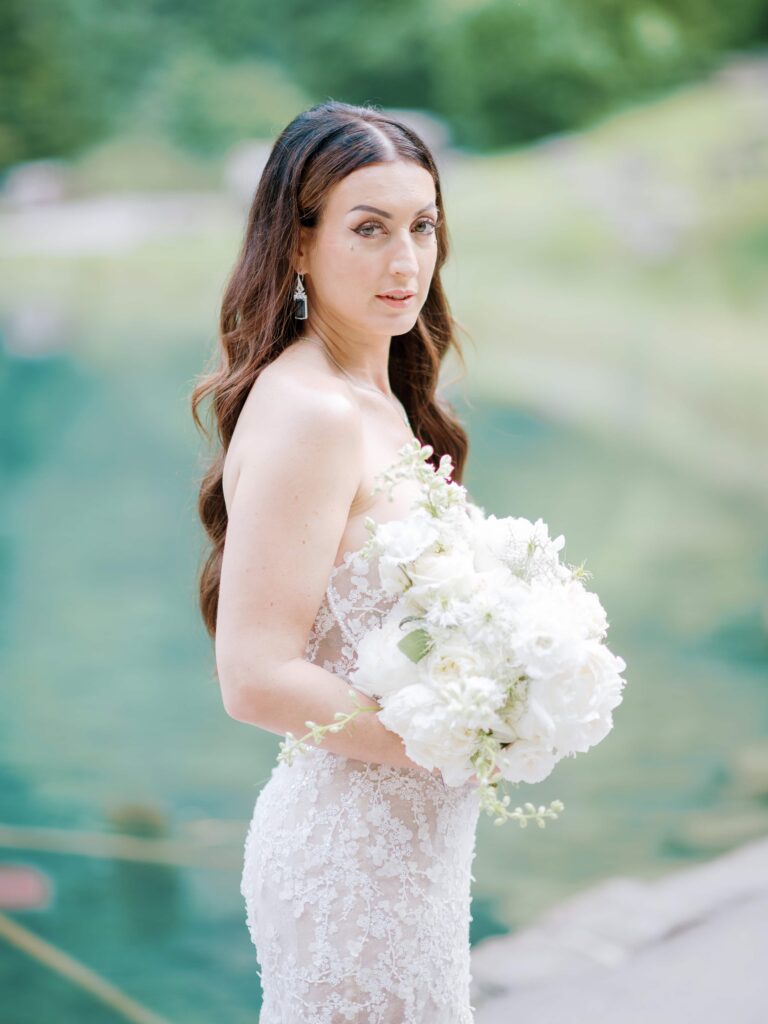 Bride standing by the lake after choosing to elope in Switzerland